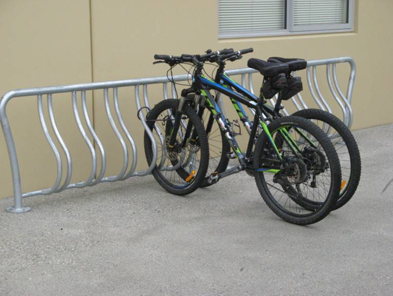 Two mountain bikes side by side in the stand. 
